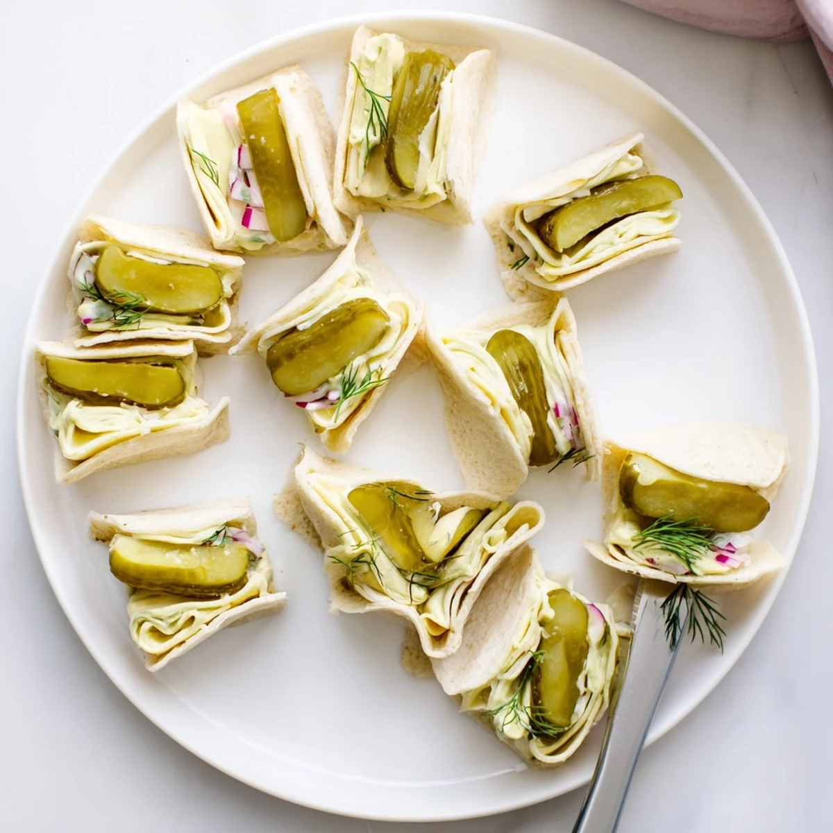 Deliciously tangy Pickle-in-a-Blanket snacks, perfect for picnics or parties.  