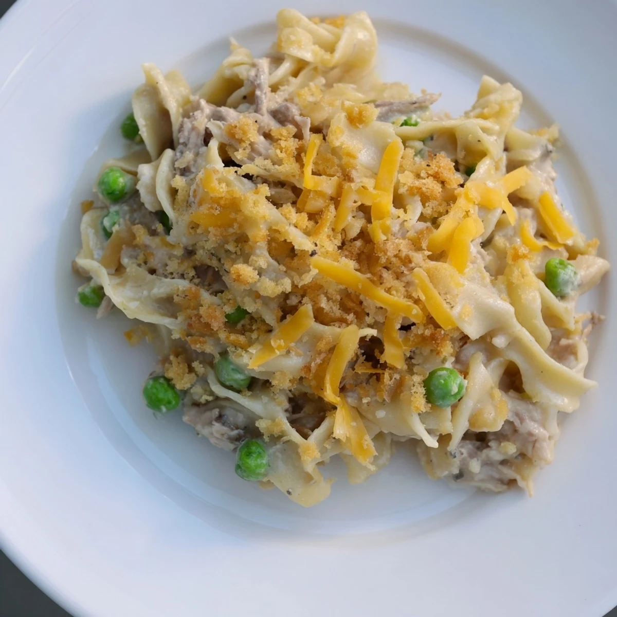 Golden brown Creamy Tuna Noodle Casserole with a crispy Ritz cracker topping, ready for serving.