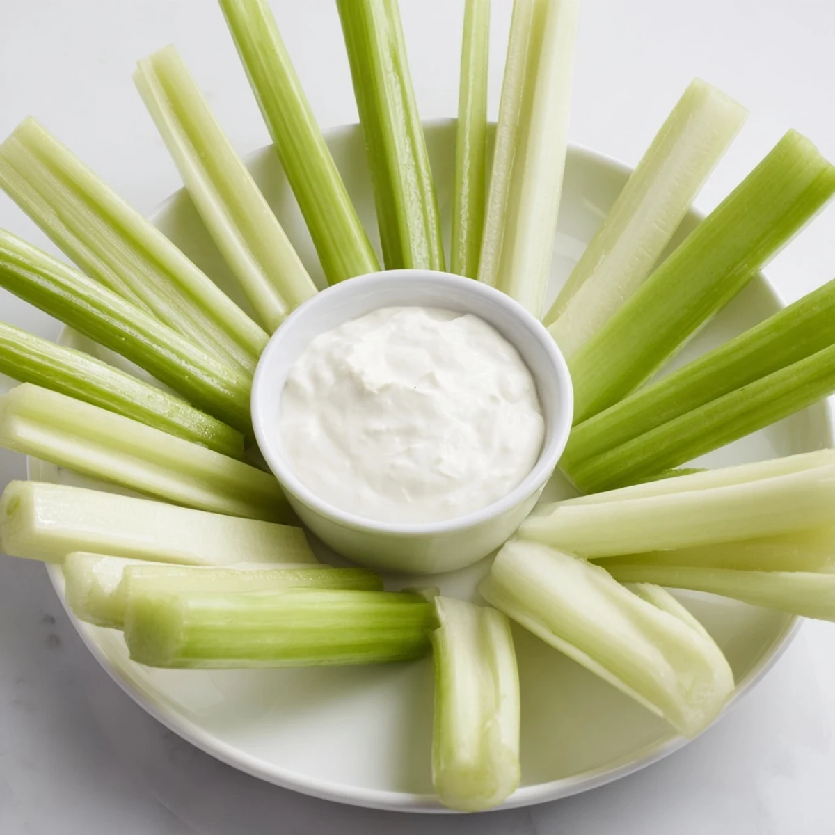 The Rustic Wheel appetizer, boasting crisp celery and meat sticks ready for dipping.