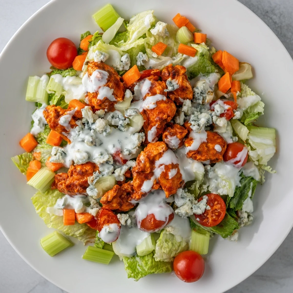 This vibrant Buffalo Chicken Chopped Salad features spicy, tender chicken pieces tossed with crisp romaine, diced celery, and creamy blue cheese crumbles.