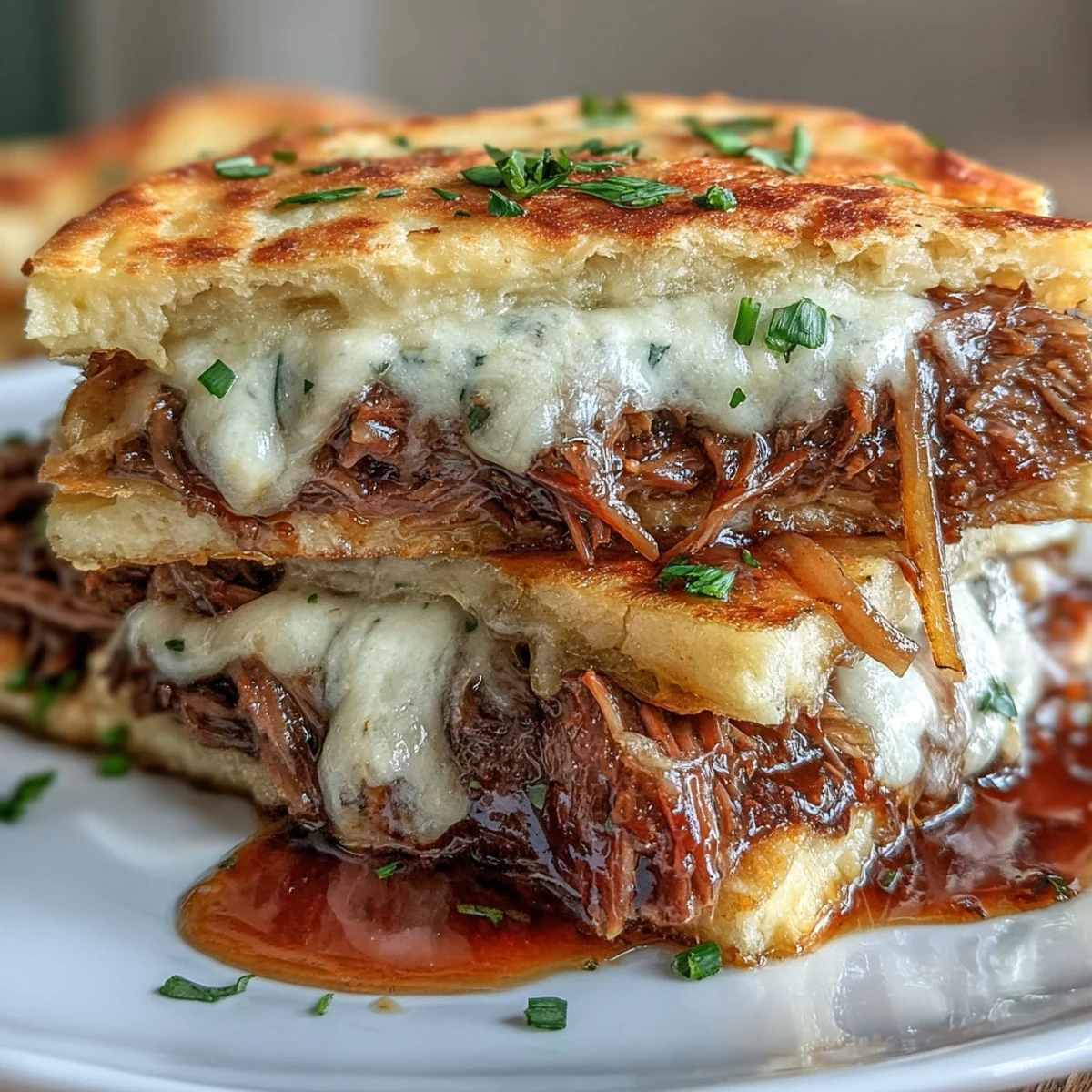 Slow-cooked shredded beef and melted provolone cheese piled on warm, garlic-seasoned naan bread, served with a side of rich jus for dipping.