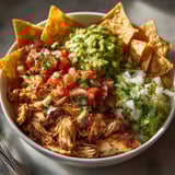 Loaded Tex-Mex Snack Plate: Melty Monterey Jack over rotisserie chicken with crisp tortilla chips.
