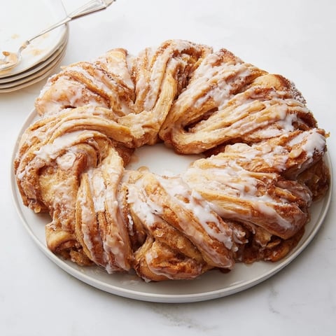 Fluffy Giant Snowflake Sweet Roll centerpiece, golden brown, iced, is perfect for breakfast.