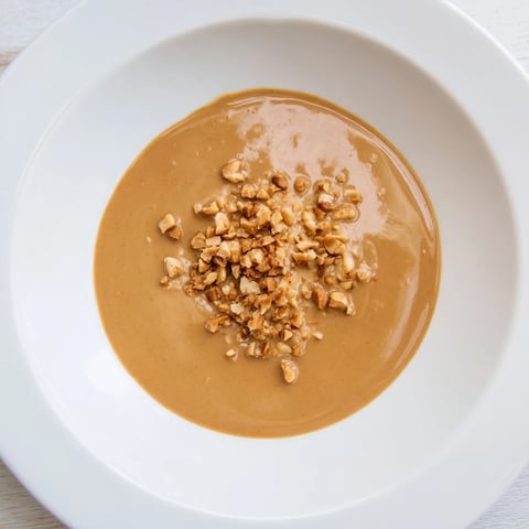 Creamy Indonesian satay sauce, glossy and aromatic, ideal for perfectly grilled chicken skewers or tofu.