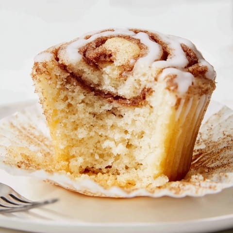 Close-up of soft Cinnamon Swirl Ricotta Cupcakes cooling, ready for a sweet glaze.