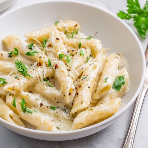 Indulge in Creamy Garlic Penne Pasta, a savory and rich comfort dish.  