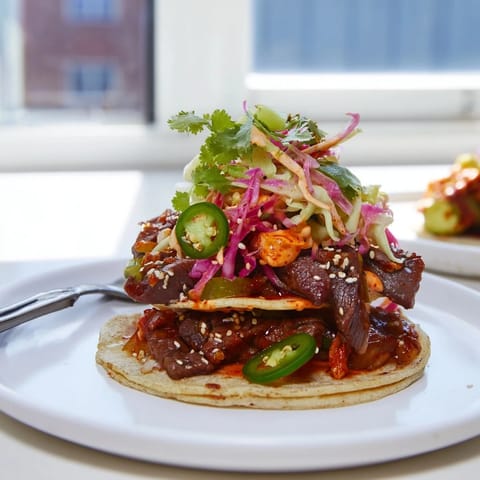 Flavorful Korean bulgogi tacos with a delightful drizzle of creamy ube sauce.  