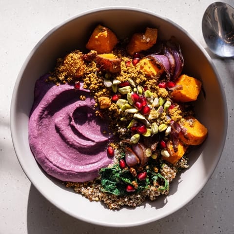 Colorful roasted winter vegetables topped with pistachio-maple crumble in spiced winter bowls.  