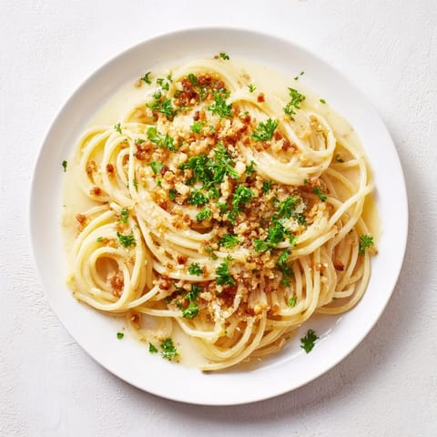Al dente Garlic Butter Pasta coated in a silky sauce and sprinkled with crispy bacon bits.