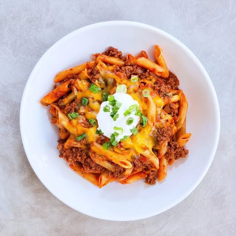 This family-friendly Easy Beef Enchilada Pasta combines flavorful ground beef with penne and sauce.
