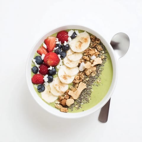 A delicious, festive Gingerbread Cookie Matcha Smoothie Bowl with fresh berries, perfect for breakfast.