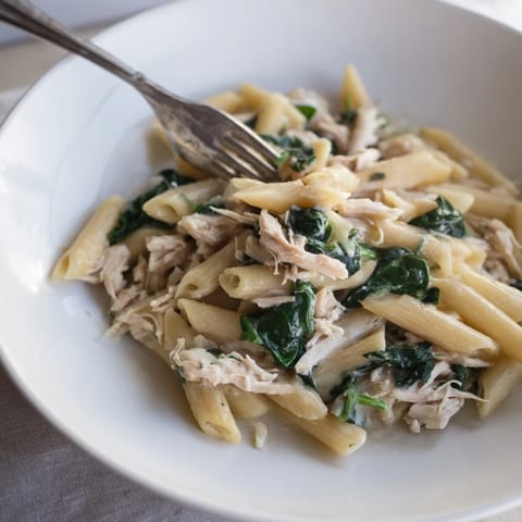 A steaming bowl of comforting One-Pot Creamy Spinach & Turkey Christmas Pasta, ready to savor.