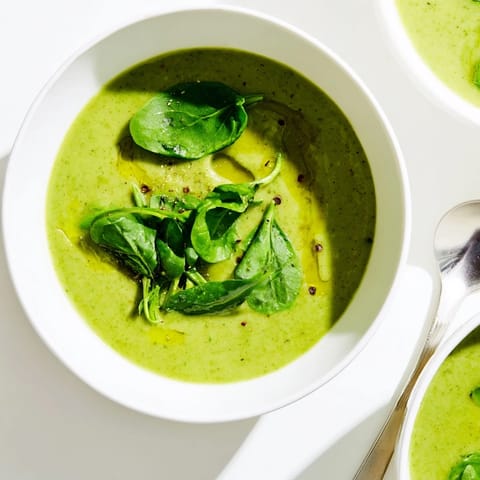 Close-up shot of Big Green Immunity-Boosting Vegetable Soup, highlighting its creamy texture from blended broccoli, asparagus, and soaked cashews.  