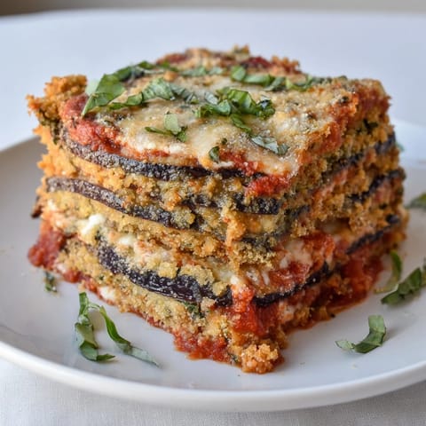 Golden-brown Eggplant Parmesan Lasagna is bubbling, layered with cheese and a rich tomato sauce.