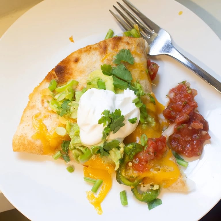 Easy Avocado Cheddar Grilled Quesadilla recipe; buttery tortilla, creamy avocado, ready to serve.