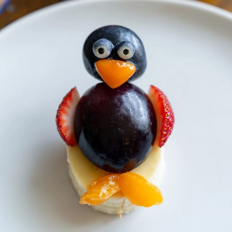 Freshly assembled Penguin Fruit Skewer Army featuring strawberries, grapes, and citrus, ready to enjoy.