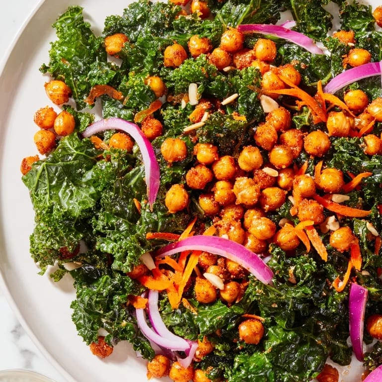 A healthy and delicious bowl of Kale Salad with Roasted Chickpeas, featuring vegan ingredients.