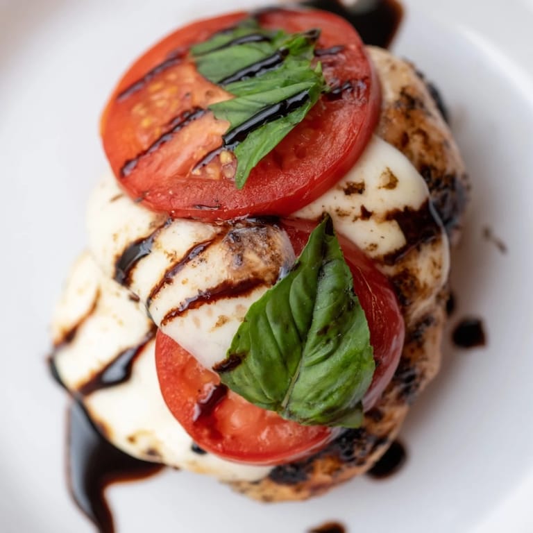 Sizzling Caprese Chicken Skillet in a cast-iron pan with colorful tomatoes and basil, ideal for quick, gluten-free family meals.