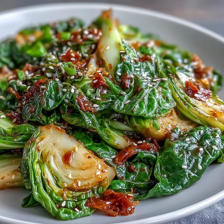 Vibrant Spicy Cabbage Stir Fry featuring tender-crisp cabbage, fresh ginger, and red chilies, perfect for a quick vegan meal.