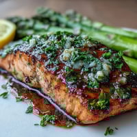 Juicy salmon fillets seared in garlic butter with crisp asparagus, perfect for a quick and healthy spring dinner.  