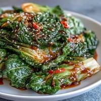 Spicy Cabbage Stir Fry with garlic and chili, wok-tossed to crisp-tender perfection in a savory soy glaze.