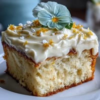 Bright baby shower lemon sunshine cake with delicate edible flowers.